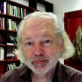 a headshot-style picture of Charles Siewert, with a bookshelf in the background
